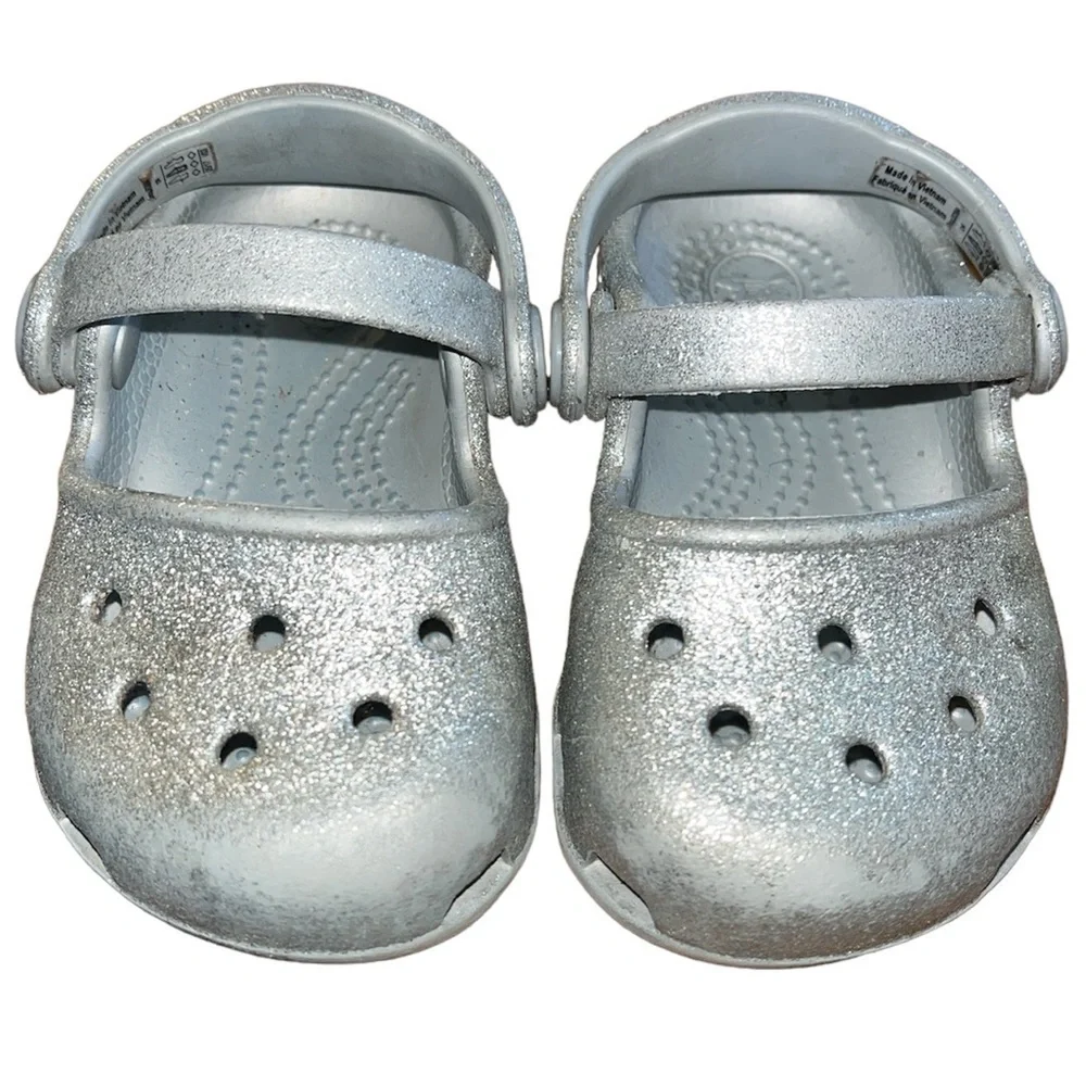 Baby’s silver glitter Crocs.  Baby’s size 4