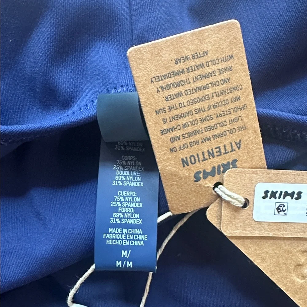 SKIMS size tags dark