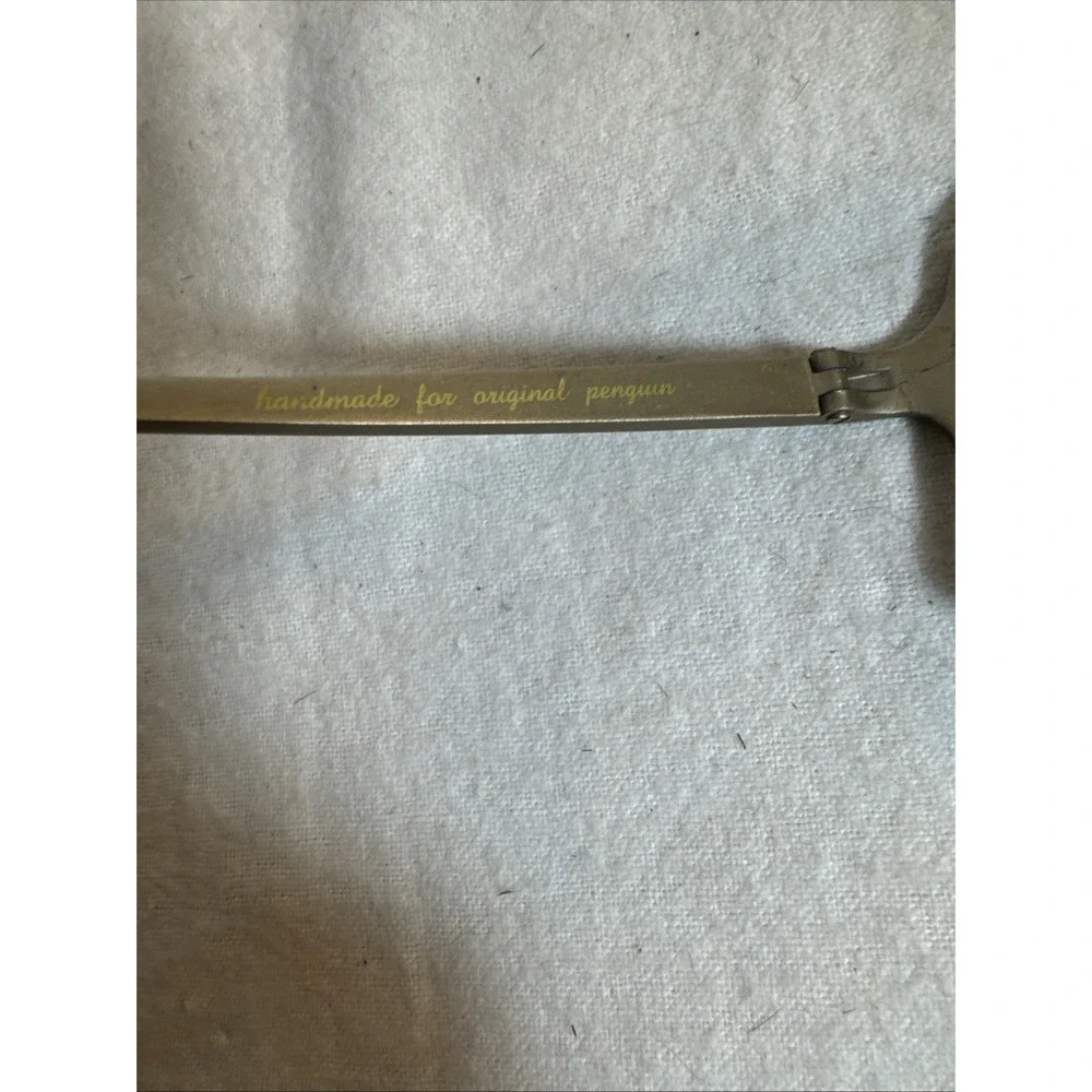 Original Penguin metal scratches may