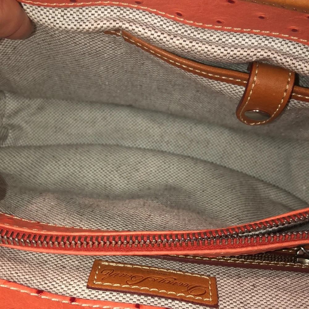 Dooney & Bourke red trades additional