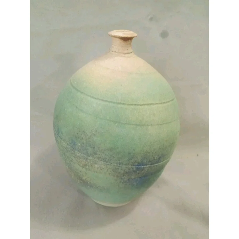 Ceramic Vase with a Blue-green Glaze and a Textured Surface.