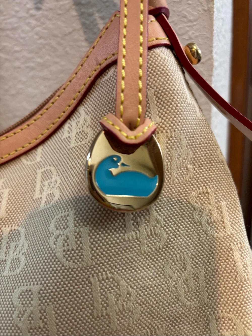 Dooney & Bourke tan this plaque