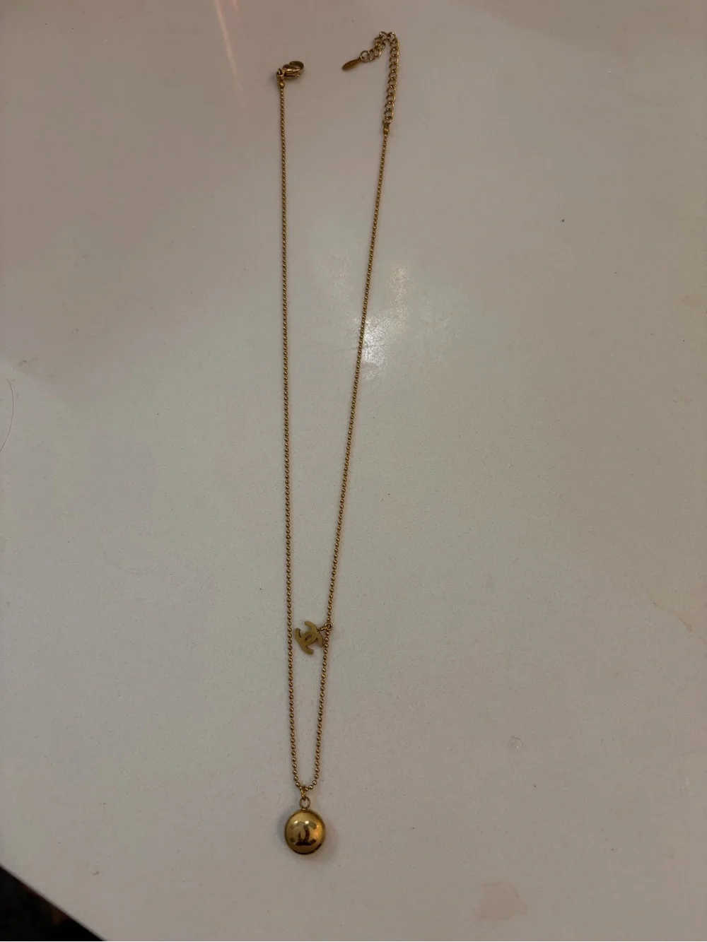 CHANEL Gold Tone Layered Necklace with Round Pendant and Logo Charm