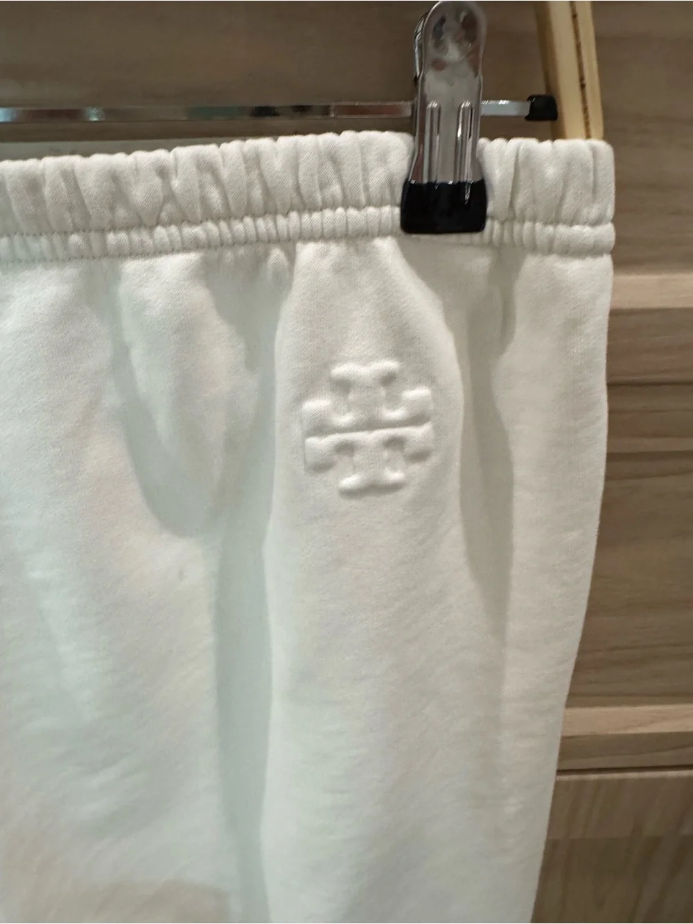 Tory Burch features hand